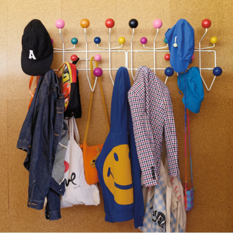 The Eames Hang-It-All from Herman Miller in a linear fashion being used for family accessories.