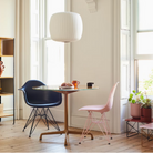 The Eames Molded Plastic Armchair by Herman Miller x HAY in a living room.