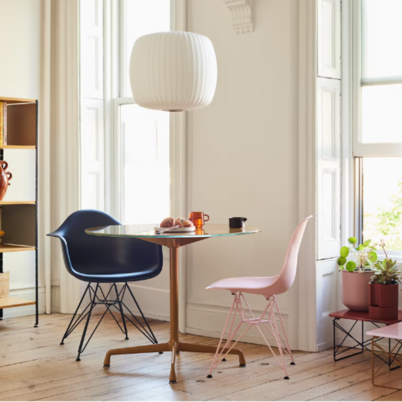 The Eames Molded Plastic Armchair by Herman Miller x HAY in a living room.
