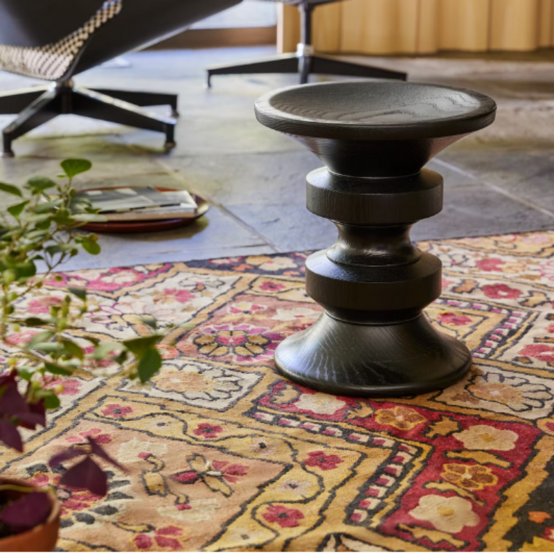 The Eames Turned Stool from Herman Miller in a family room.