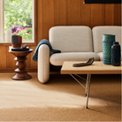 The Eames Turned Stool from Herman Miller in a living space.