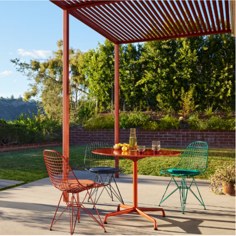 The Eames Wire Chair from Herman Miller, designed by Herman Miller x HAY in an outdoor dining set up. all-groups