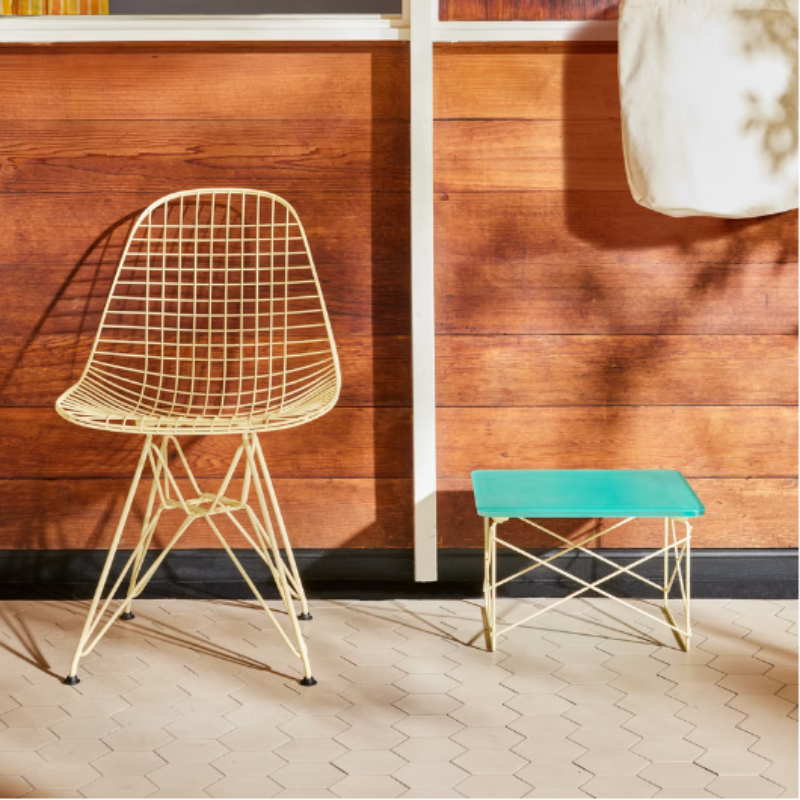 The Eames Wire Chair from Herman Miller, designed by Herman Miller x HAY outdoors with the low table.