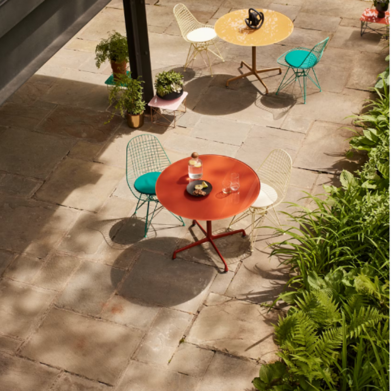 The Eames Wire Chair from Herman Miller, designed by Herman Miller x HAY in an outdoor lounge space. all-groups