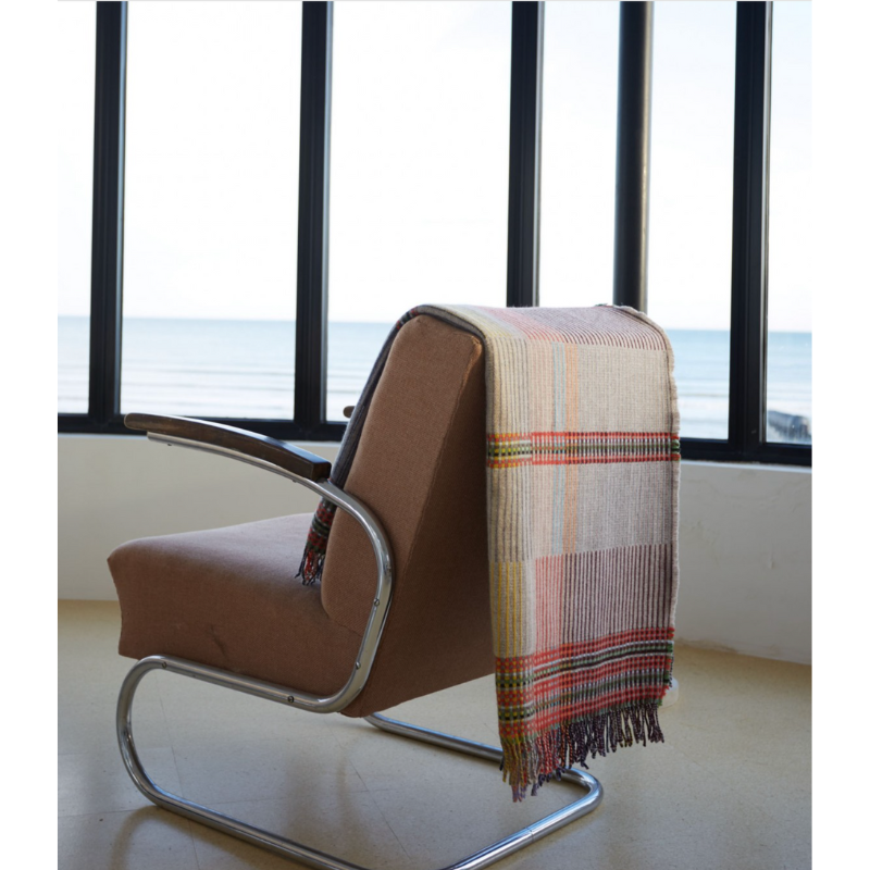 Woven in merino lambswool, Wallace & Sewell's Pinstripe throws combine bold-colored blocks with fine, detailed vertical stripes. This double-sided design also has a contrasting pixelated border and makes a stunning addition to a room.