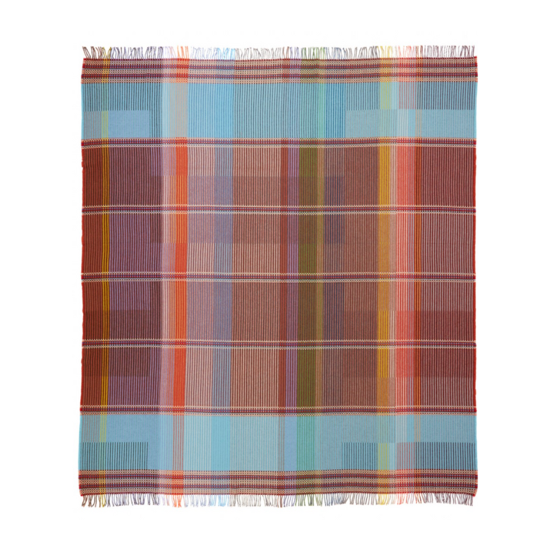 The Beatrix Throw by Wallace & Sewell is made of woven merino lambswool. The Pinstripe collection combines bold-colored blocks with fine, detailed vertical stripes. This double-sided design also has a contrasting pixelated border and is a stunning room addition