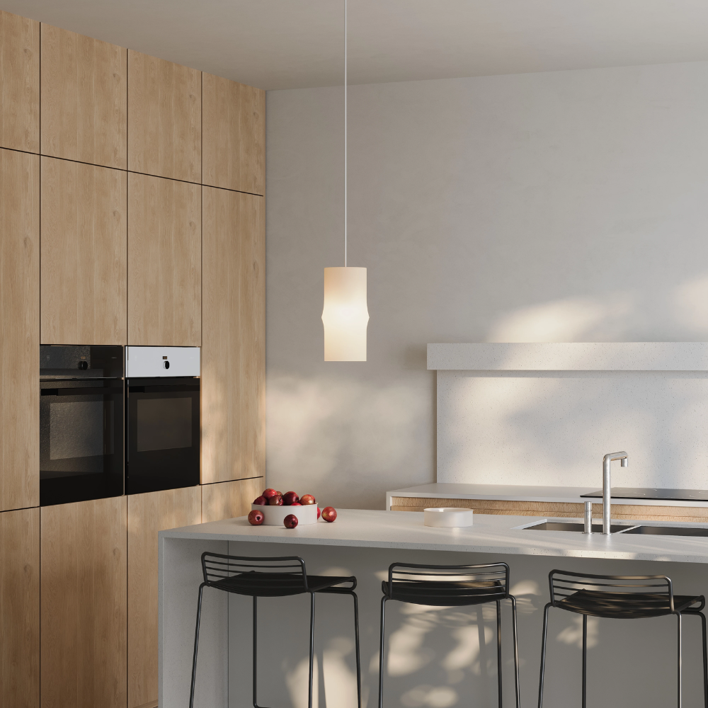 The Bamboo Small Pendant Light from Gantri with the white cord in a dining space.