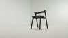 The Bok Upholstered Dining Chair from Ethnicraft in black oak with black leather in a studio video.