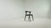 The Bok Upholstered Dining Chair from Ethnicraft in black oak with grey fabric in a studio video.