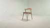 The Bok Upholstered Dining Chair from Ethnicraft in oak with cognac leather in a studio video.