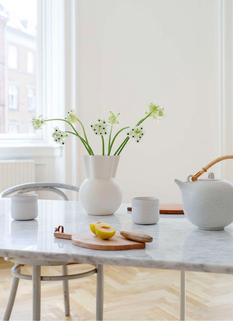 The Sweeping Top Vase by Spring Copenhagen was designed by Eva Stæhr-Nielsen, who, during her career was awarded numerous international design prizes in Milan, Paris, Tokyo and the United States, among many others. Today, her stoneware design is much sought after by collectors all over the world. 