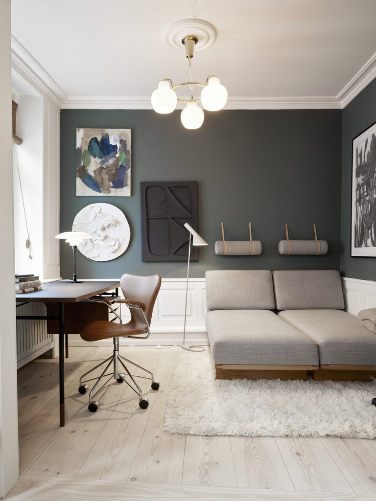 The PH 3½-2½ glass table lamp is designed based on the principle of a reflective three-shade system, which directs the majority of the light downwards. The shades are made of hand blown opal three-layer glass, which is glossy on top and sandblasted matte on the underside, giving a soft and diffused light distribution. Designed by Poul Henningsen.