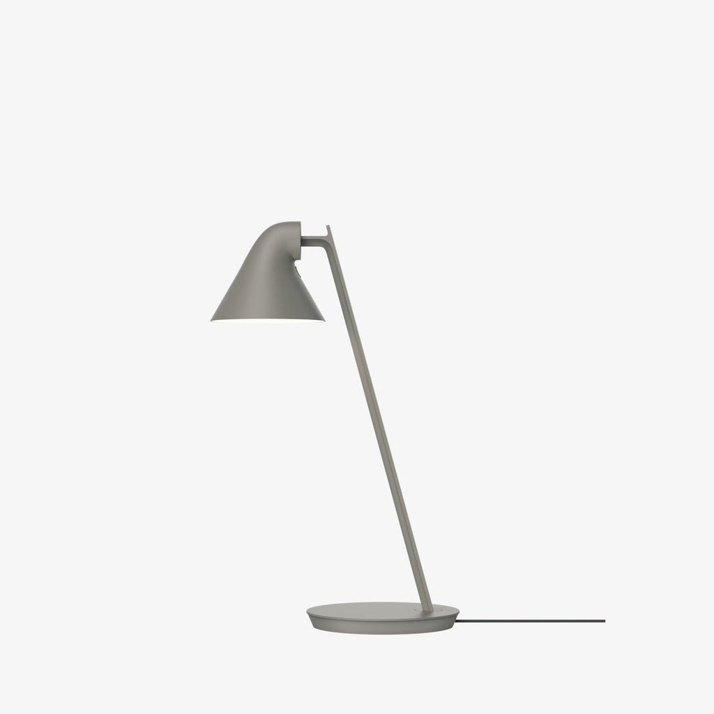 The NJP Mini Table Lamp is a petite version of the NJP Table Lamp with downscaled proportions. Both are a modernistic take on the classic architect lamp with the flexibility of two joints on the extensive arm. The characteristic rear-shade opening toward the arm allows stemless adjustment of the organic head. Designed by Nendo Japanese design studio and designer Oki Sato. 