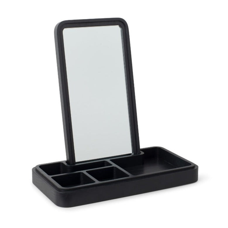 mirror box in blackMirror Box by Spring Copenhagen is a smart design that scores high on both aesthetics and functionality. The lid conceals a mirror, which you can place upright in the box. The box itself is split into smaller compartments, which are ideal for items such as jewelry, hair bands, keys, and cards. 