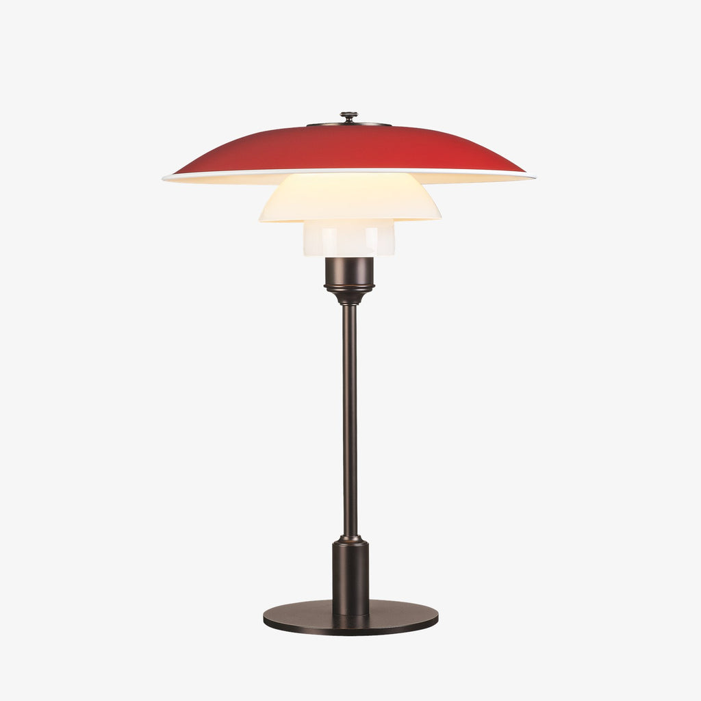 The PH 3½-2½ table lamp is designed based on the principle of a reflective three-shade system, which directs the majority of the light downwards. The shades are made of mouth-blown opal three-layer glass, which is glossy on top and sandblasted matt on the underside, giving a soft and diffuse light distribution. Designed by Poul Henningsen.