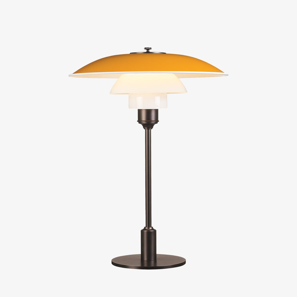 The PH 3½-2½ table lamp is designed based on the principle of a reflective three-shade system, which directs the majority of the light downwards. The shades are made of mouth-blown opal three-layer glass, which is glossy on top and sandblasted matt on the underside, giving a soft and diffuse light distribution. Designed by Poul Henningsen.
