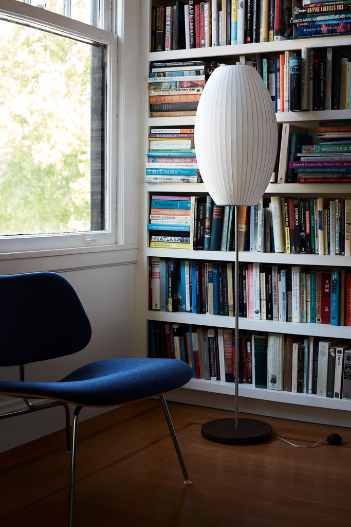 The Nelson Cigar Lotus Floor Lamp, an elongated shade set on a steel lamp stand, illuminates any room with a warm glow. Available in two elegant finishes. Apart of the  timeless Nelson Bubble Lamps series, designed in 1952, beautifully complement contemporary interiors.