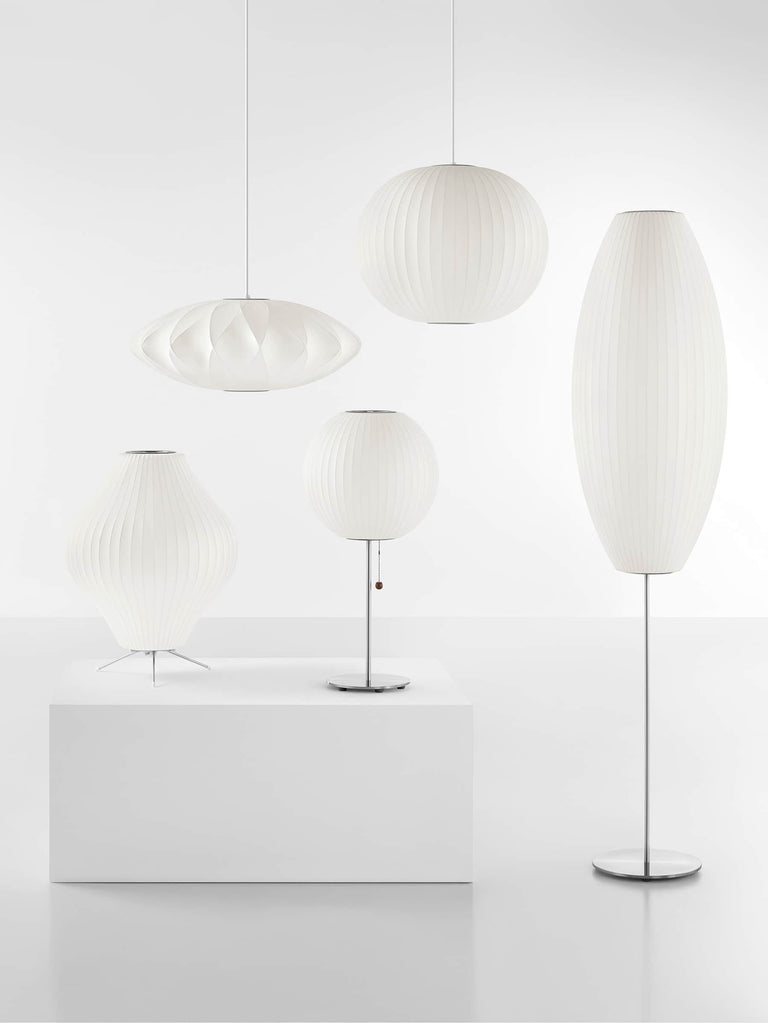 The Nelson Pear Tripod Table Lamp, a flared, pear-shaped shade set on a steel tripod base, emits warm, diffused light. The timeless Nelson Bubble Lamps, originally designed in 1952, complement contemporary interiors as beautifully as they do mid-century homes.