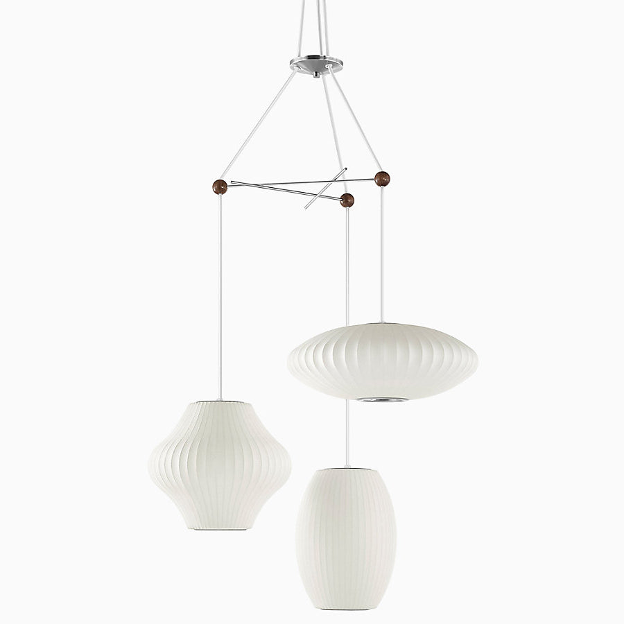 The Nelson Triple Bubble Lamp Fixture by George Nelson for Herman Miller is the  perfect solution to hang your three favorite Bubble Pendants from the designer's Bubble Lamp Series. The fixture is made up of three crossing metal rods fused together with wooden spheres to create a playful display for illumination in a space. Each Bubble lamp can be installed with up to nineteen inches of diameter. Fixture only, pendants sold separately.