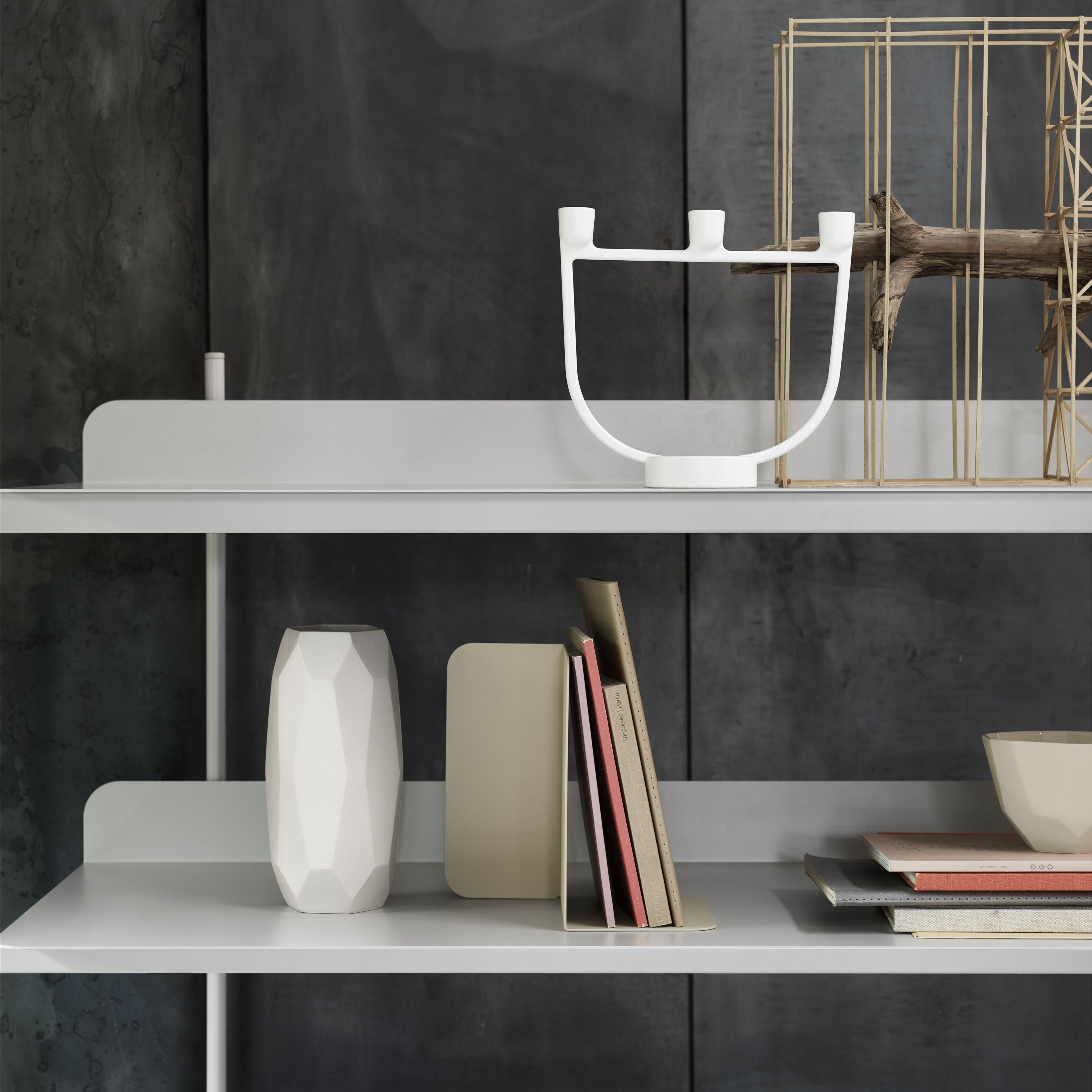 The graphic Open Candelabra by Jens Fager for Muuto is a contemporary update to a timeless design with three candle holders placed in a symmetric line.