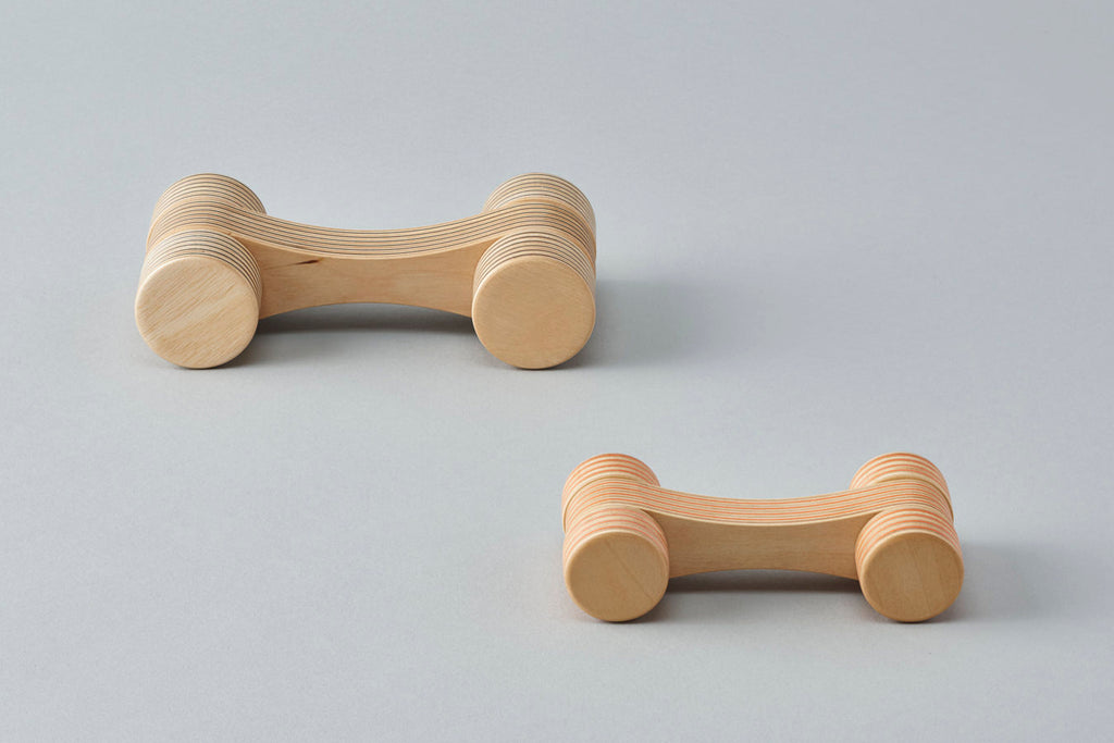 A car-shaped object with a smoothly abstracted design achieved by slimming down the form to the max. Offers the beauty of the plywood’s continuous striped pattern. Designed by Drill Design.