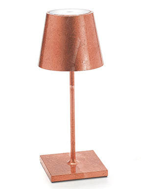 The Poldina Pro Table Lamp by Ai Lati Lights for Zafferano features a sleek and small body and offers a crisp and bright light to its setting. Ideal for indoor and outdoor settings with its 9-hour rechargeable battery life and portable body makes the perfect accent to a space. The fixture is made up of painted aluminum with a polycarbonate diffuser and LED light source. Its square base ensures a sturdy display.