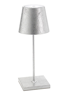 The Poldina Pro Table Lamp by Ai Lati Lights for Zafferano features a sleek and small body and offers a crisp and bright light to its setting. Ideal for indoor and outdoor settings with its 9-hour rechargeable battery life and portable body makes the perfect accent to a space. The fixture is made up of painted aluminum with a polycarbonate diffuser and LED light source. Its square base ensures a sturdy display.