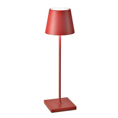 The Poldina Pro Table Lamp by Ai Lati Lights for Zafferano features a sleek and small body and offers a crisp and bright light to its setting. Ideal for indoor and outdoor settings with its 9-hour rechargeable battery life and portable body makes the perfect accent to a space. The fixture is made up of painted aluminum with a polycarbonate diffuser and LED light source. Its square base ensures a sturdy display.