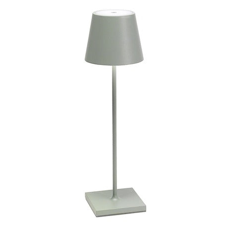 The Poldina Pro Table Lamp by Ai Lati Lights for Zafferano features a sleek and small body and offers a crisp and bright light to its setting. Ideal for indoor and outdoor settings with its 9-hour rechargeable battery life and portable body makes the perfect accent to a space. The fixture is made up of painted aluminum with a polycarbonate diffuser and LED light source. Its square base ensures a sturdy display.
