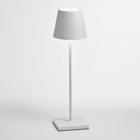 The Poldina Pro Table Lamp by Ai Lati Lights for Zafferano features a sleek and small body and offers a crisp and bright light to its setting. Ideal for indoor and outdoor settings with its 9-hour rechargeable battery life and portable body makes the perfect accent to a space. The fixture is made up of painted aluminum with a polycarbonate diffuser and LED light source. Its square base ensures a sturdy display.