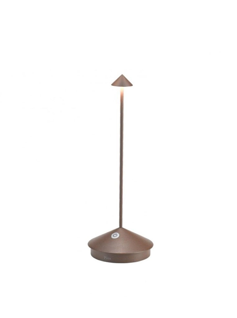 The Pina Pro Rechargeable Lamp by Ai Lati for Zafferano features a sleek and small body and wide base to anchor the lamp. Its clean design perfectly suits small settings offering a crisp and bright light to a space. Features a die-cast LED lamp with polycarbonate diffuser, 13+ hours of rechargeable battery life, and portable body makes the Pina Pro an excellent accents to a space. Touch-dimmable. Contact charging base with USB cable included. Suitable for indoor or outdoor use.