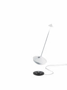 The Pina Pro Rechargeable Lamp by Ai Lati for Zafferano features a sleek and small body and wide base to anchor the lamp. Its clean design perfectly suits small settings offering a crisp and bright light to a space. Features a die-cast LED lamp with polycarbonate diffuser, 13+ hours of rechargeable battery life, and portable body makes the Pina Pro an excellent accents to a space. Touch-dimmable. Contact charging base with USB cable included. Suitable for indoor or outdoor use.