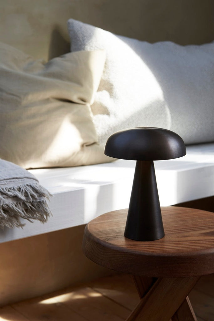 Como SC53, a portable table lamp from Space Copenhagen. Crafted from anodized aluminum, Como’s sturdy base tapers up towards a softy curved, mushroom-shaped shade. This battery-powered lamp can operate for eleven hours at the highest setting, with an extra battery option that allows additional operating. It is easily recharged with a magnetic USB cable or a charging tray.