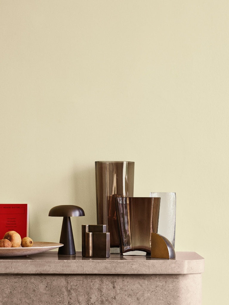Como SC53, a portable table lamp from Space Copenhagen. Crafted from anodized aluminum, Como’s sturdy base tapers up towards a softy curved, mushroom-shaped shade. This battery-powered lamp can operate for eleven hours at the highest setting, with an extra battery option that allows additional operating. It is easily recharged with a magnetic USB cable or a charging tray.