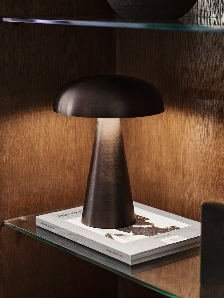 Como SC53, a portable table lamp from Space Copenhagen. Crafted from anodized aluminum, Como’s sturdy base tapers up towards a softy curved, mushroom-shaped shade. This battery-powered lamp can operate for eleven hours at the highest setting, with an extra battery option that allows additional operating. It is easily recharged with a magnetic USB cable or a charging tray.