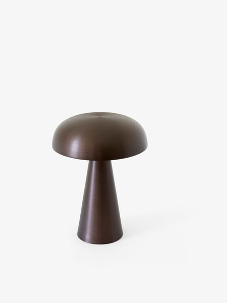 Como SC53, a portable table lamp from Space Copenhagen. Crafted from anodized aluminum, Como’s sturdy base tapers up towards a softy curved, mushroom-shaped shade. This battery-powered lamp can operate for eleven hours at the highest setting, with an extra battery option that allows additional operating. It is easily recharged with a magnetic USB cable or a charging tray.