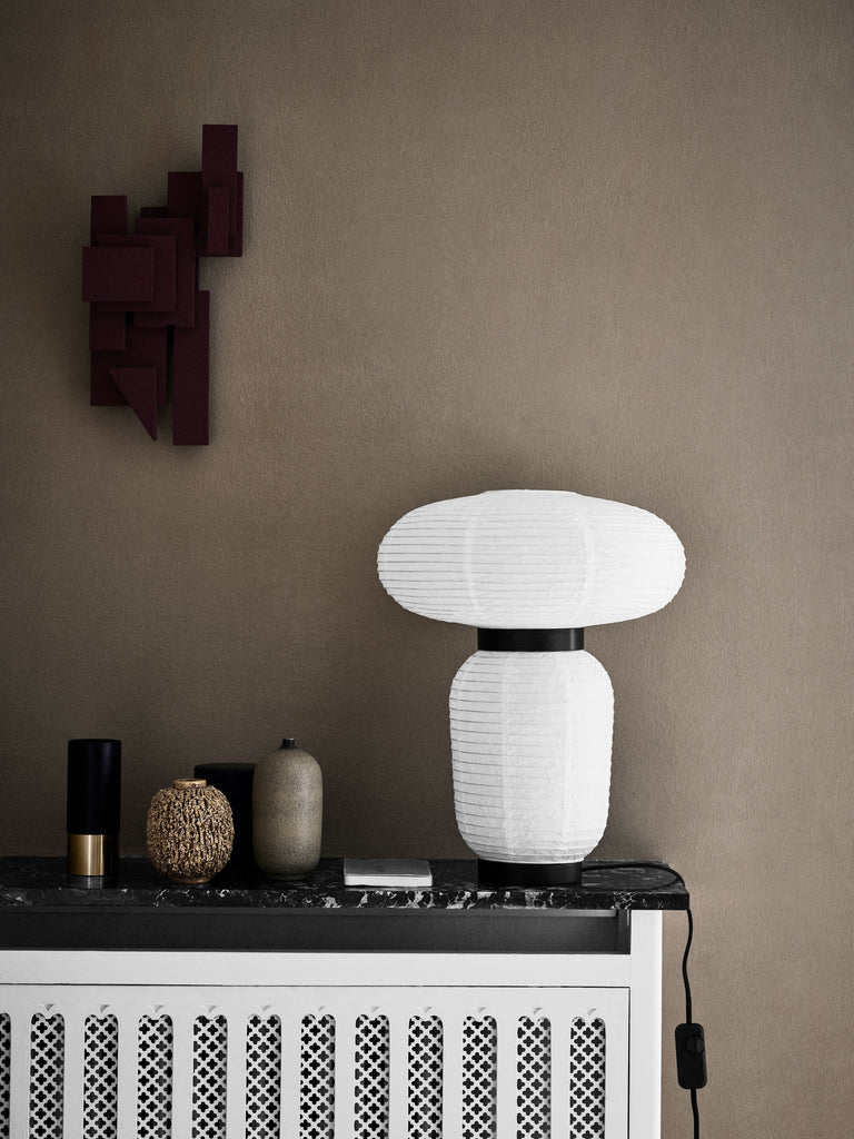 Here Hayon has dispensed with cultural formalities to create a series of lamps all in white. Hand crafted with rice paper merging various sizes and shapes together. The series is comprised of three different lantern versions and a table lamp in ivory white rice paper with black stained oak accents.