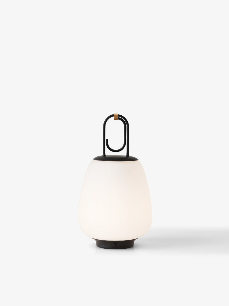 The Lucca Portable Table Lamp by Space Copenhagen for &Tradition. This elegant portable lamp, inspired by the golden glow of the Tuscan city of Lucca, mimics the warmth of the city’s nocturnal light.