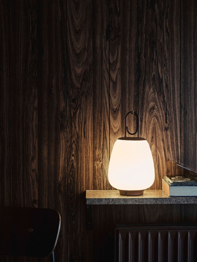 The Lucca Portable Table Lamp by Space Copenhagen for &Tradition. This elegant portable lamp, inspired by the golden glow of the Tuscan city of Lucca, mimics the warmth of the city’s nocturnal light.