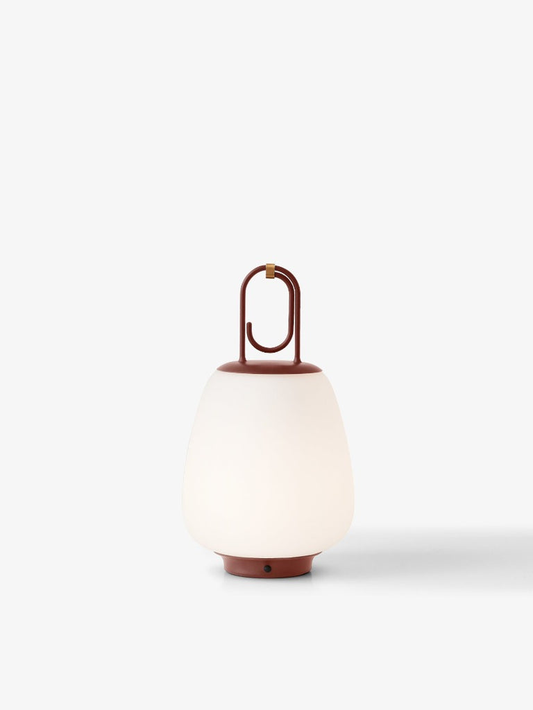 The Lucca Portable Table Lamp by Space Copenhagen for &Tradition. This elegant portable lamp, inspired by the golden glow of the Tuscan city of Lucca, mimics the warmth of the city’s nocturnal light.