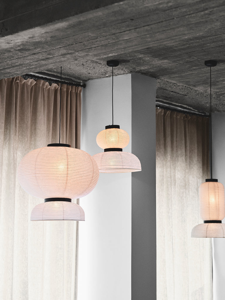 Hand crafted with rice paper merging various sizes and shapes together. The series is comprised of three different lantern versions and a table lamp in ivory white rice paper with black stained oak accents.
