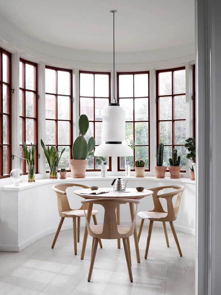 The JH3 Formakami Paper Lantern. Hand crafted with rice paper merging various sizes and shapes together. The series is comprised of three different lantern versions and a table lamp in ivory white rice paper with black stained oak accents.