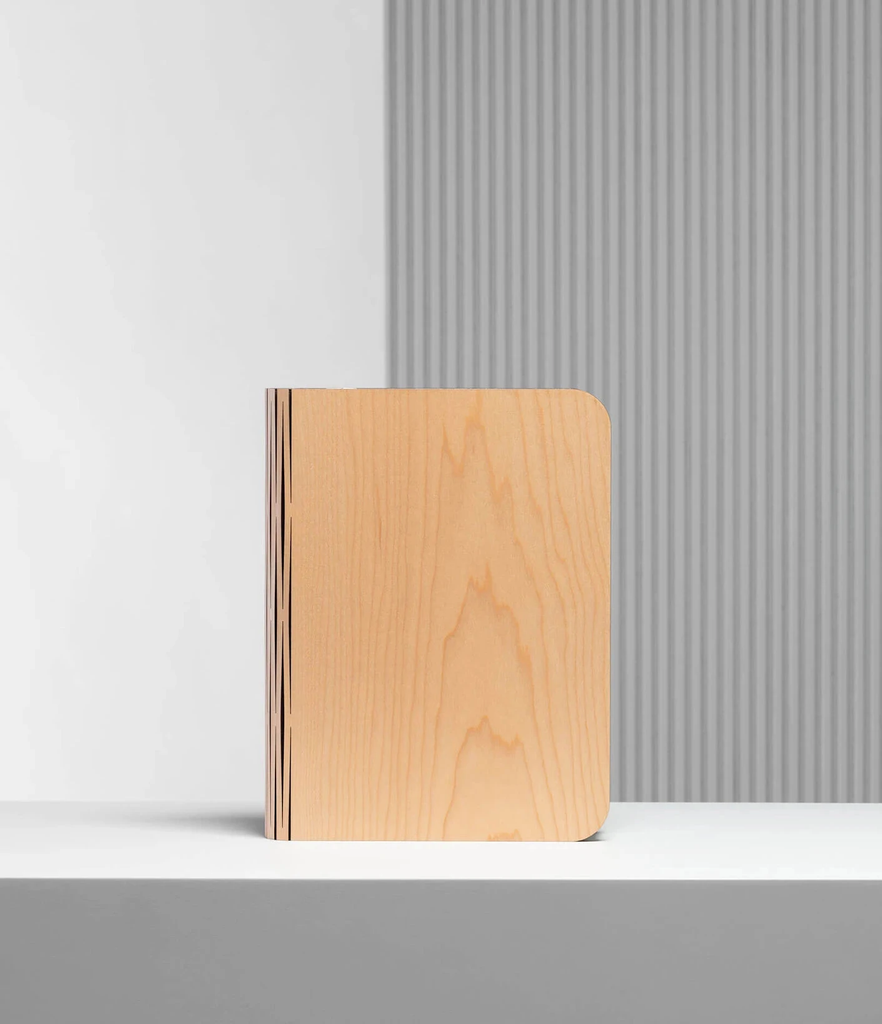 When closed, Lumio's Lito Classic Book Lamp is concealed as a handsomely crafted, hard-cover wooden book. Open it and it transforms into a sculptural light, radiating a warm glow.