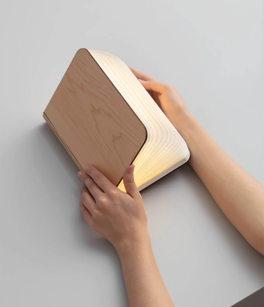 When closed, Lumio's Lito Classic Book Lamp is concealed as a handsomely crafted, hard-cover wooden book. Open it and it transforms into a sculptural light, radiating a warm glow.