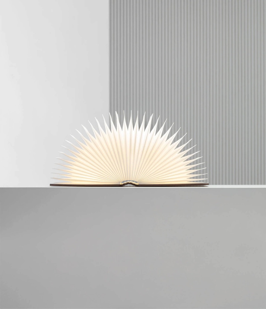 When closed, Lumio's Lito Classic Book Lamp is concealed as a handsomely crafted, hard-cover wooden book. Open it and it transforms into a sculptural light, radiating a warm glow.