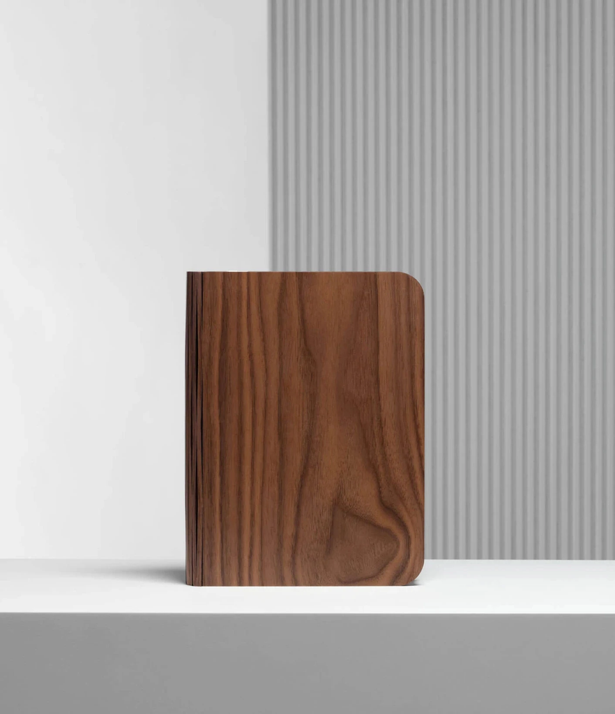 When closed, Lumio's Lito Classic Book Lamp is concealed as a handsomely crafted, hard-cover wooden book. Open it and it transforms into a sculptural light, radiating a warm glow.