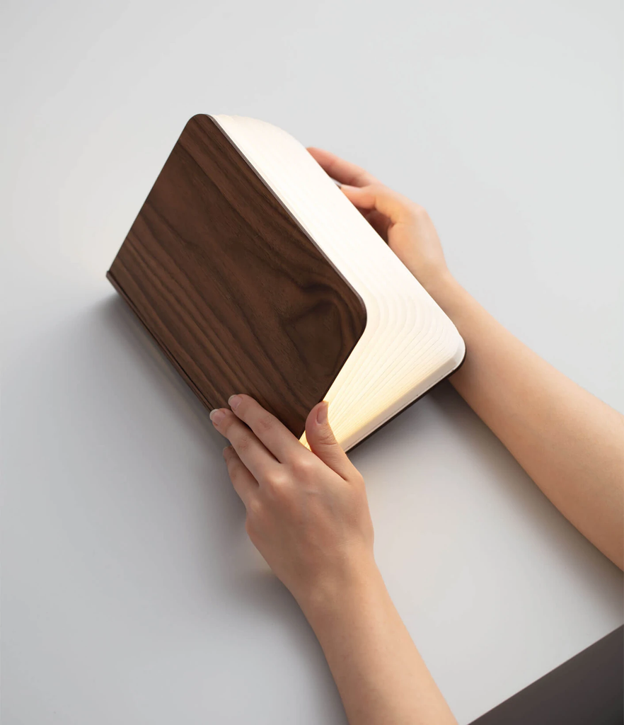When closed, Lumio's Lito Classic Book Lamp is concealed as a handsomely crafted, hard-cover wooden book. Open it and it transforms into a sculptural light, radiating a warm glow.