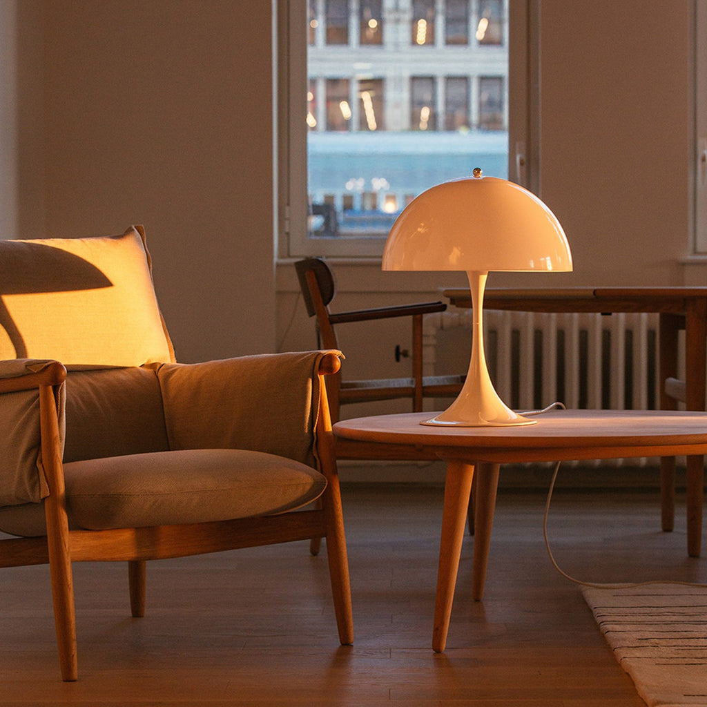 Verner Panton's classic Panthella Table Lamp was created in collaboration with Louis Poulsen in 1971. Panton’s figurative and playful design radiates his larger-than-life personality. Without compromising on quality or functionality, Panthella stands out with its organic shape, which mirrors the softest of light. With its non-glaring light, Panthella serves as a beautiful example of Panton's brilliant ability to create atmospheric illumination. 
