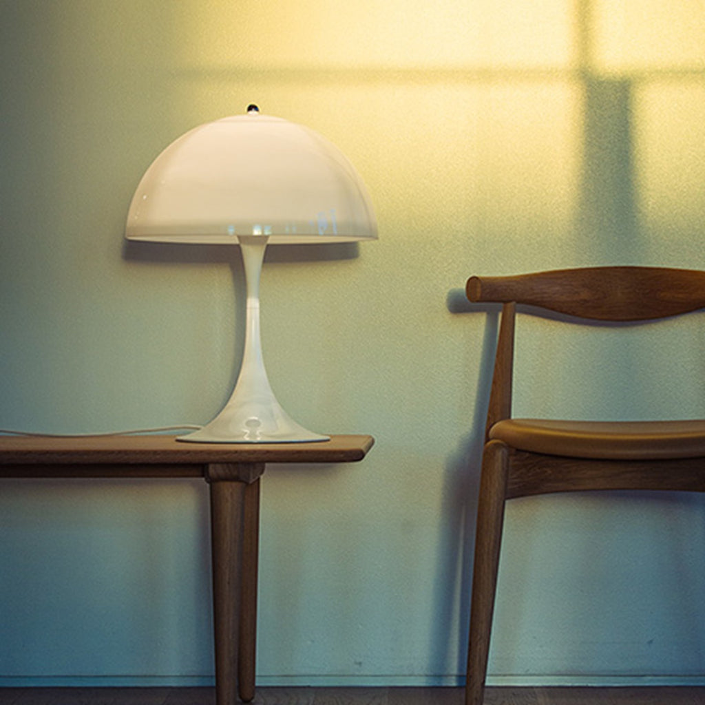 Verner Panton's classic Panthella Table Lamp was created in collaboration with Louis Poulsen in 1971. Panton’s figurative and playful design radiates his larger-than-life personality. Without compromising on quality or functionality, Panthella stands out with its organic shape, which mirrors the softest of light. With its non-glaring light, Panthella serves as a beautiful example of Panton's brilliant ability to create atmospheric illumination. 