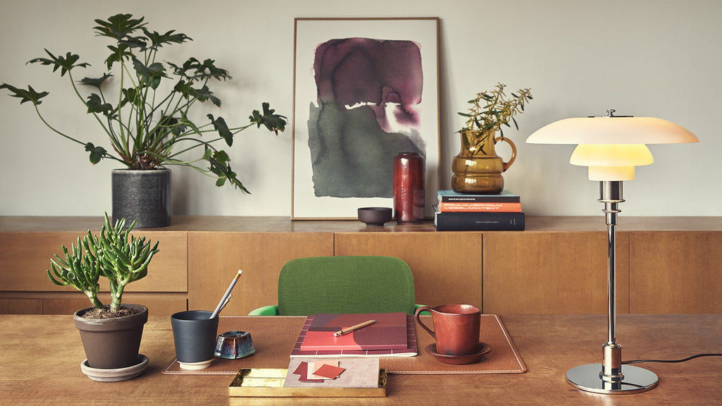 The PH 3/2 Table Light by Paul Henningsen for Louis Poulsen features a reflective three-shade system, which directs the majority of the light downwards. The shades are made of hand-blown opal three-layer glass, which is glossy on top and sandblasted matte on the underside, giving a soft and diffused light distribution.